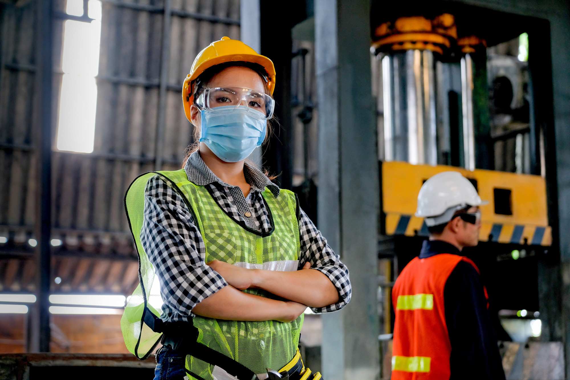 People in factory wearing protective gear